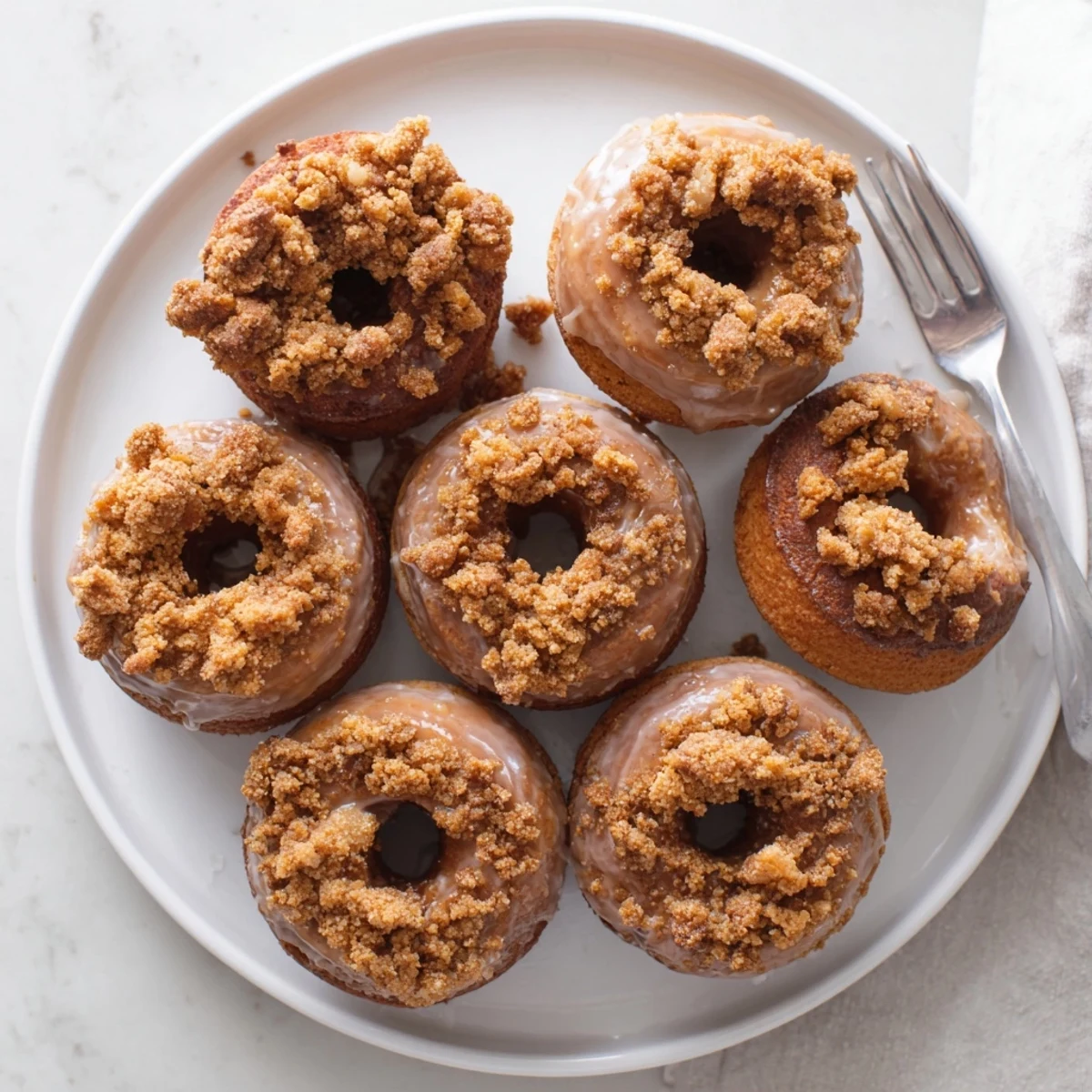Warm, fluffy Apple Butter Cinnamon Crunch Donuts topped with a crispy cereal and sugar blend.  