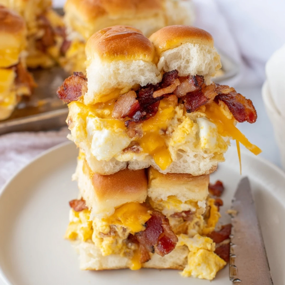 Golden Hawaiian rolls packed with scrambled eggs, bacon, and melted cheddar in each slider.