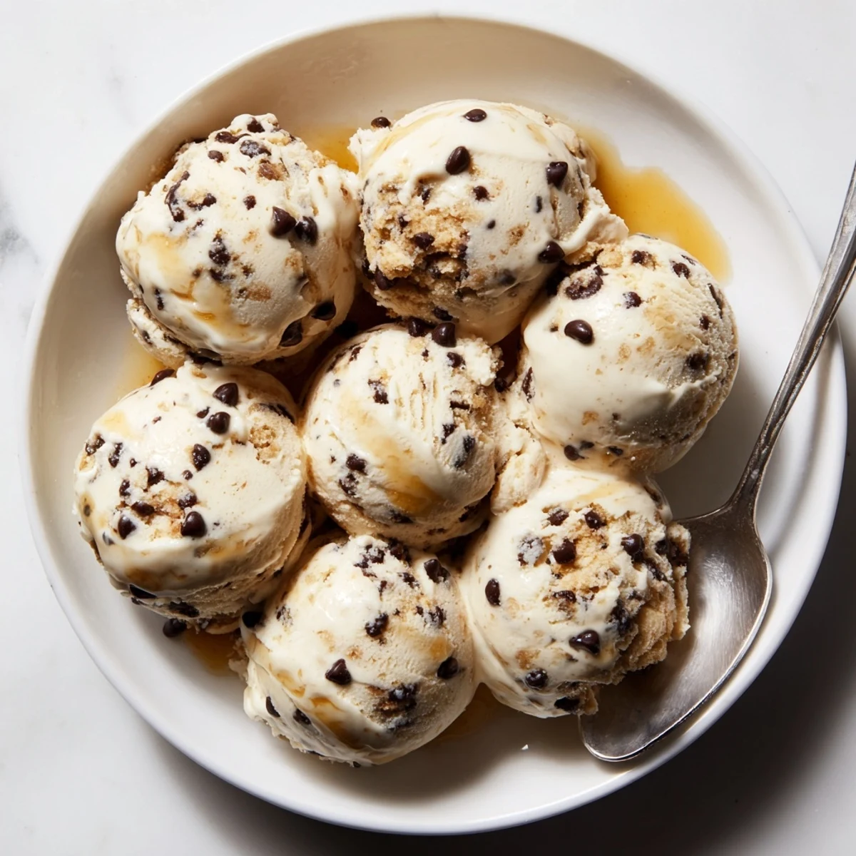 Creamy Cottage Cheese Ice Cream with Cookie Dough, drizzled in rich maple syrup.  