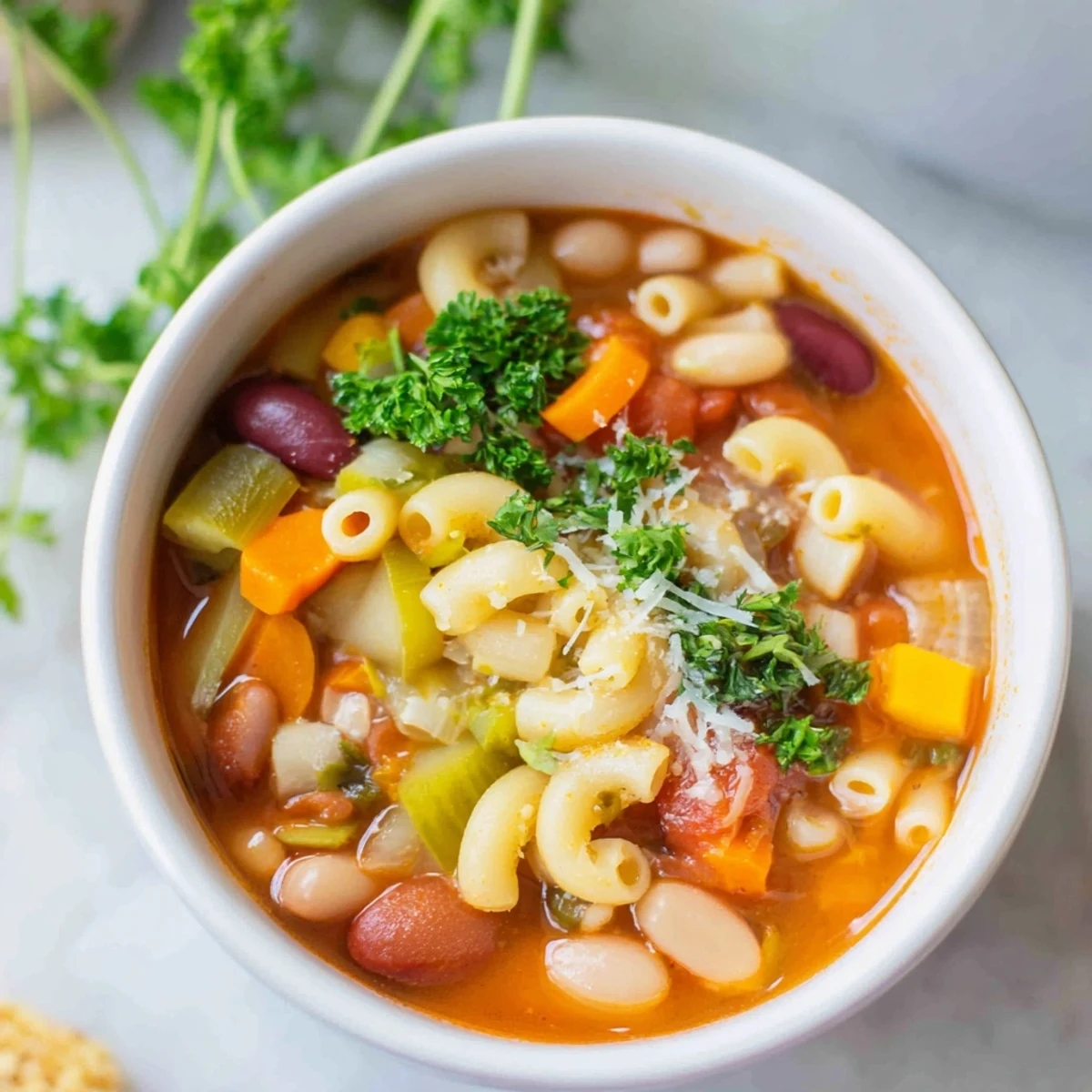 Pasta e Fagioli Soup simmering in a pot with vegetables, creating a comforting, aromatic Italian soup.