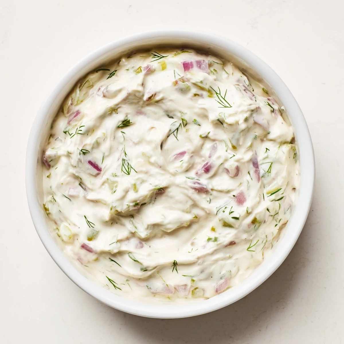 Creamy sweet and sour pickle relish dip with visible relish pieces, perfect for dipping chips.