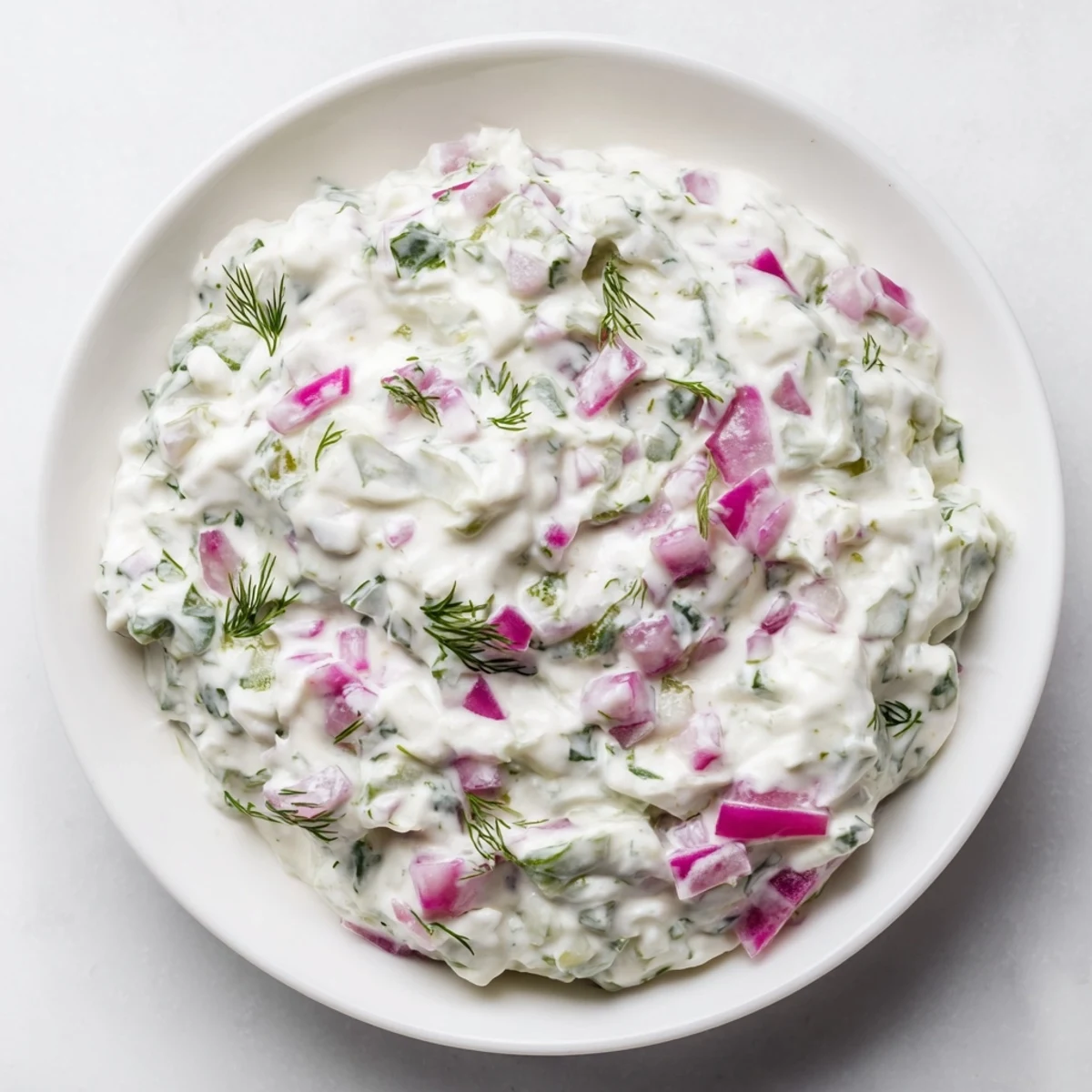 Fresh dill enhances this sweet and sour pickle relish dip, presented with crackers ready to enjoy.