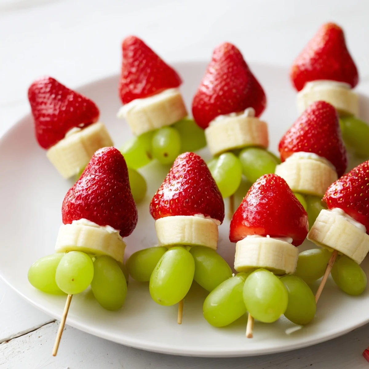 Elf Hat Strawberry Skewers: colorful fruit skewers, sweet strawberries, and banana rounds arranged for fun snacking.