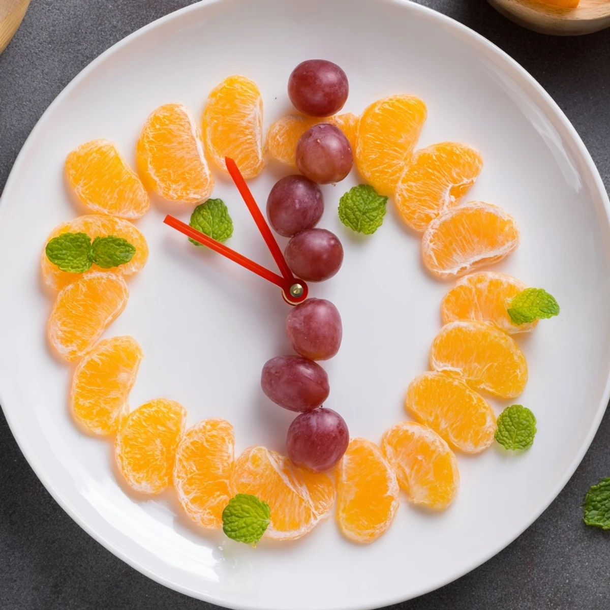 Vibrant grape and orange slice clock face artfully arranged, a refreshing fruit platter perfect for brunch.