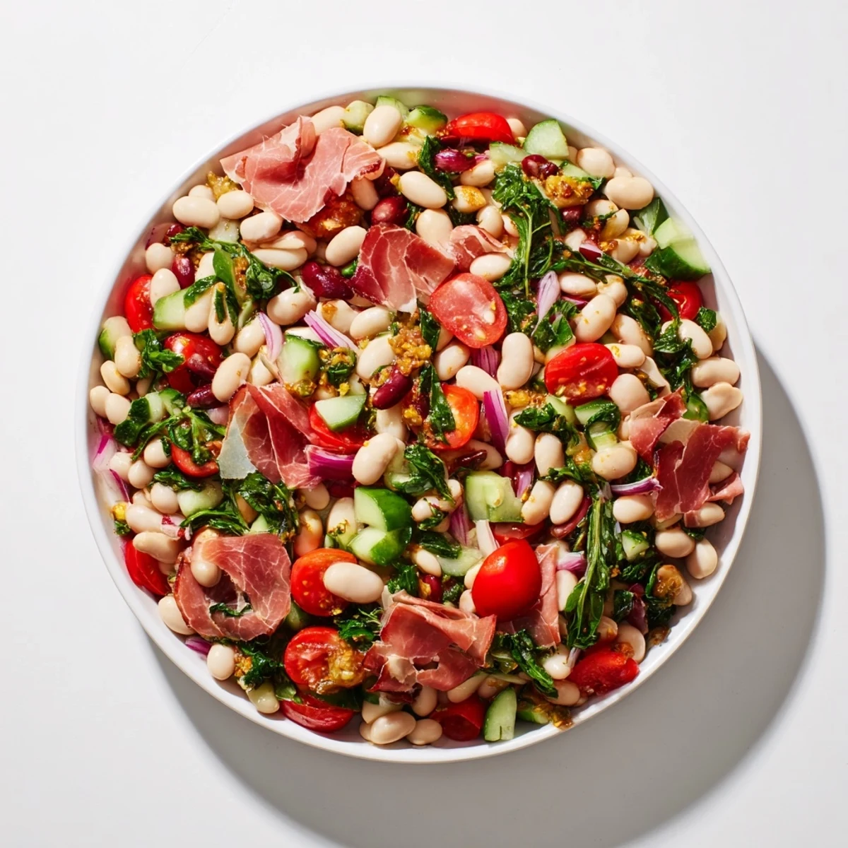 Close-up of a colorful Dense Bean Salad with Prosciutto, highlighting the fresh ingredients and textures.