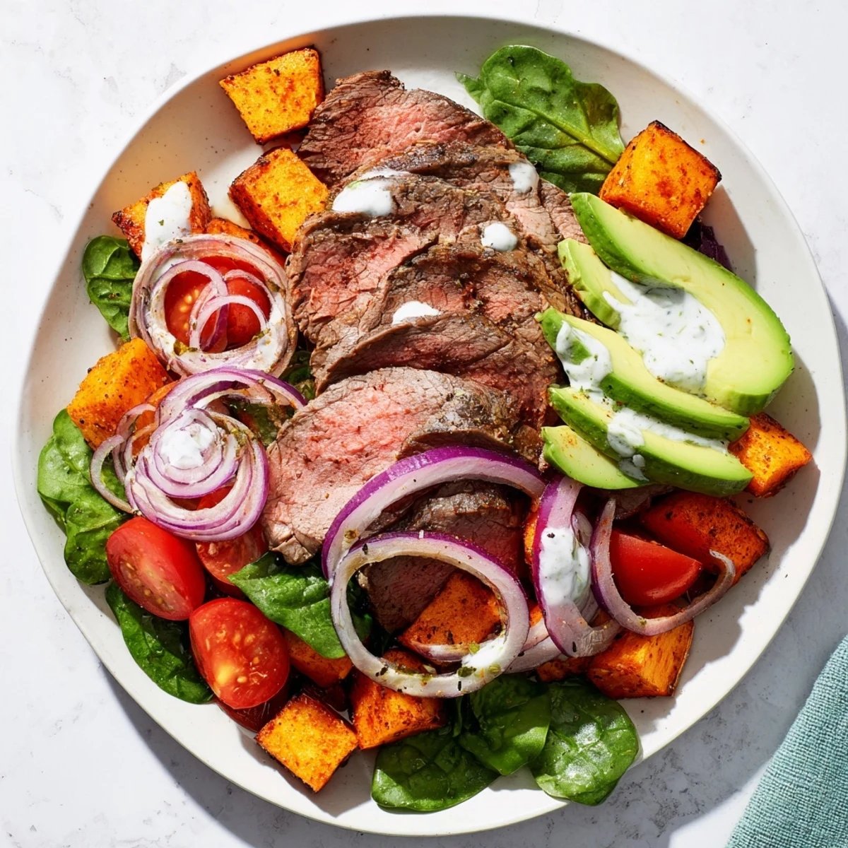 Imagine a satisfying lunch or dinner: A fresh Beef Avocado Sweet Potato Bowl, loaded with greens and flavor.