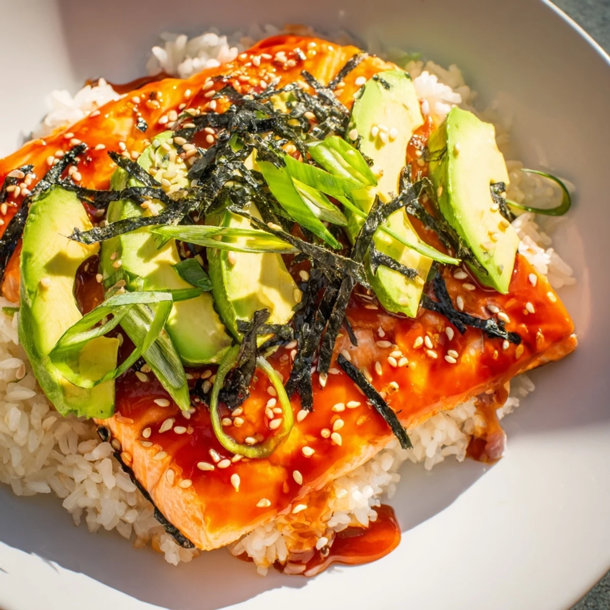 Beautifully plated Emily Mariko-Inspired Salmon Bowl: a flavorful fusion of sweet-spicy salmon over a bed of rice.