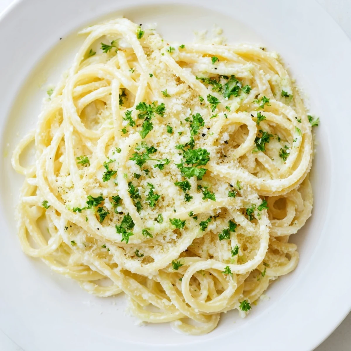 Creamy, homemade Pasta Alfredo Cottage Hack, coated in a light sauce and sprinkled with fresh parsley.