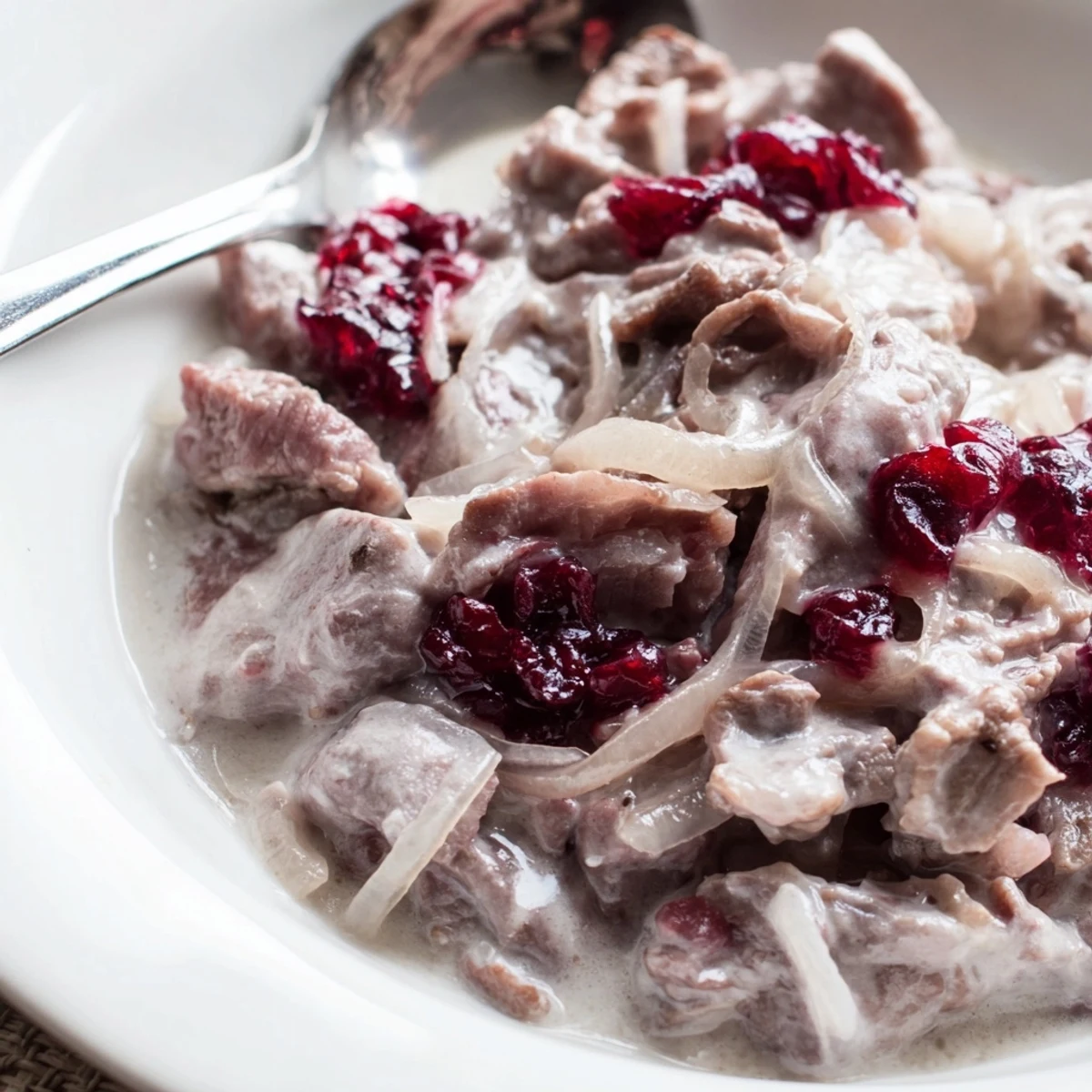 Finnish reindeer stew simmering in a hearty broth, ready to be served with creamy mashed potatoes.