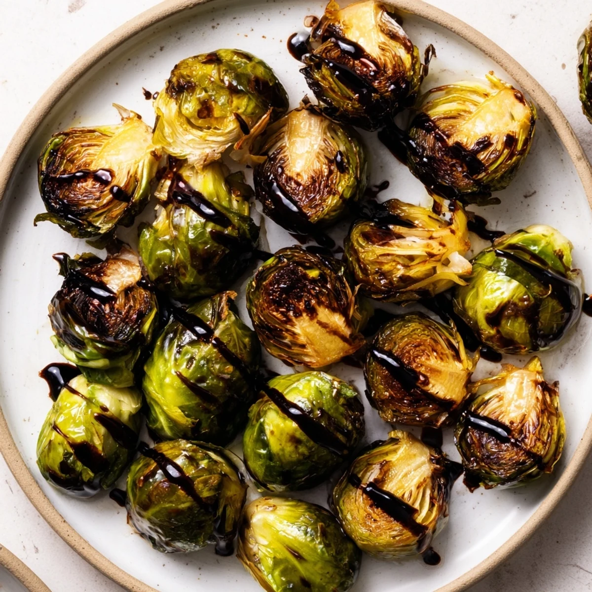 Caramelized Brussels sprouts with balsamic glaze, roasted until tender and golden on a baking sheet.