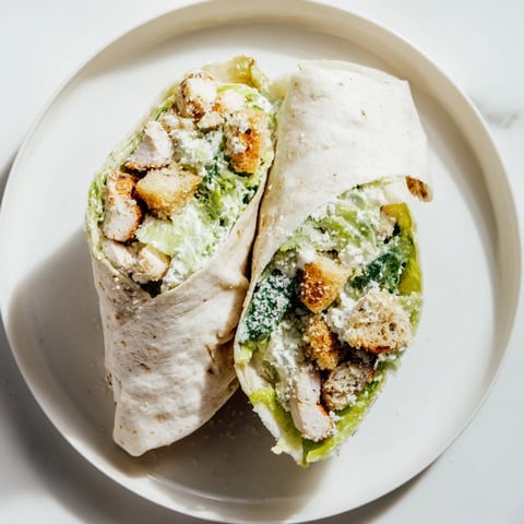 Delicious Chicken Caesar Wraps, bursting with creamy dressing, savory chicken, and crunchy croutons.