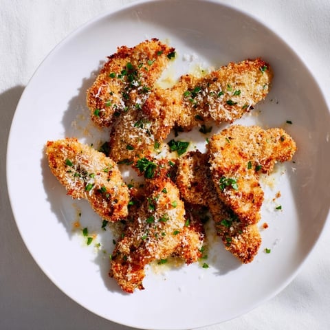 Golden-brown Garlic Parmesan Chicken Tenders, crispy and ready for a delicious family meal.