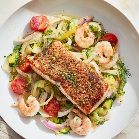 Plongeons dans lOcéan Poisson Bleu: baked blue fish fillets with vibrant vegetables, ready to serve and enjoy.