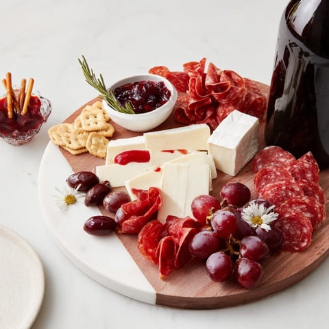 Show-stopping Ruby Red Wine Stain Board with red wine-soaked cheeses, meats, and olives ready to serve.