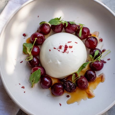 The Moonlit Lagoon salad features creamy burrata surrounded by juicy blueberries and grapes.