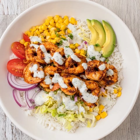 A colorful Cajun shrimp taco bowl, featuring plump, cooked shrimp and fresh toppings, ready to enjoy.