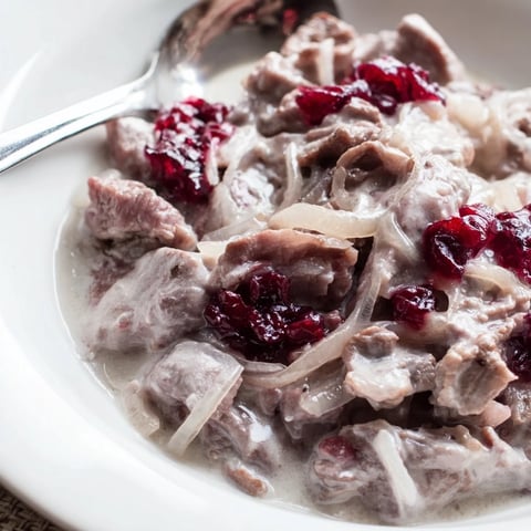 Finnish reindeer stew simmering in a hearty broth, ready to be served with creamy mashed potatoes.