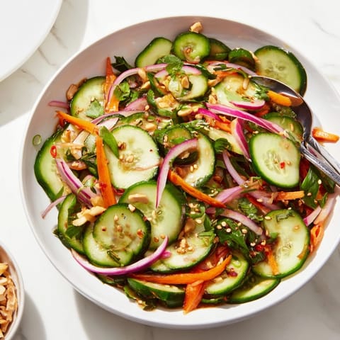 Cucumber salad remix drizzled with tangy fish sauce and topped with sesame seeds.  