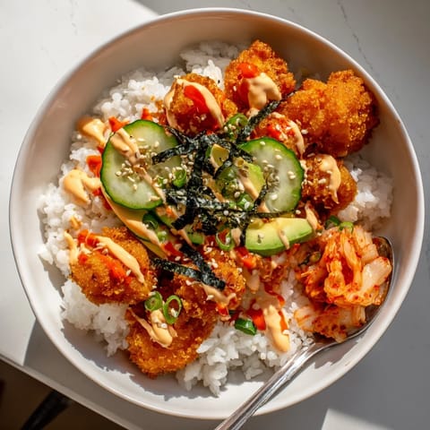 Deliciously layered Crispy Salmon Rice Bowl featuring golden rice and spicy mayo drizzle.  