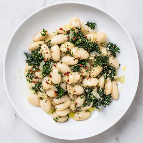 Hearty Garlicky Beans with Winter Greens, featuring tender beans and lush greens, perfect for a cozy meal.