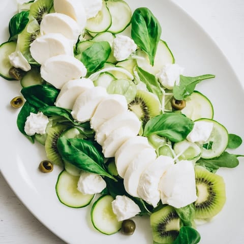 This Emerald Isle Greenscape salad features vibrant green ingredients and a flavorful pesto dressing.