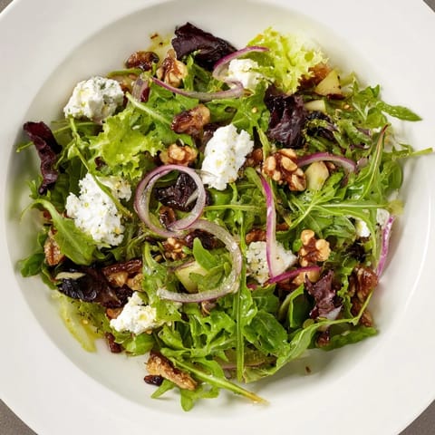 Fresh Spiced Honey and Date Goat Cheese Salad, drizzled with warm honey dressing and walnuts, a beautiful starter.