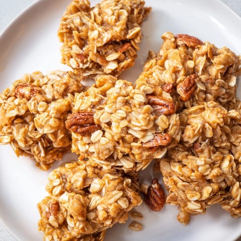 Crispy Honey Nut Granola Clusters: a close-up shows textured oats and nuts baked to golden perfection.