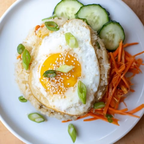 This delicious crispy egg rice bowl showcases a perfectly cooked egg with a medley of fresh vegetables.