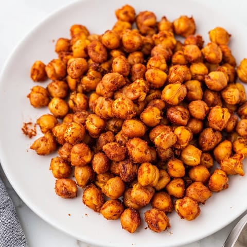 Golden-brown Crispy Chickpea Snack roasted with paprika and cumin, served warm in a rustic bowl.  