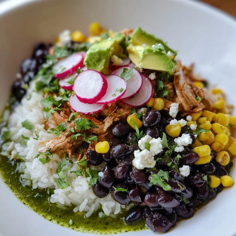 Beautifully plated Green Enchiladas Rice Bowl ready to enjoy, with a lime wedge for added zest.