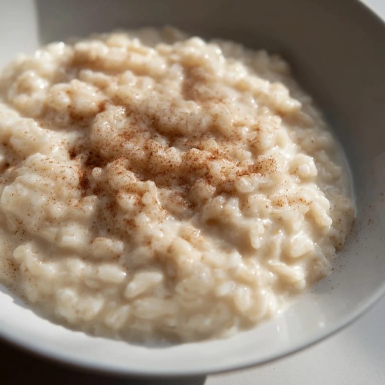 Steaming, creamy Rice Pudding with Leftover Rice, perfectly flavored and delicious for dessert.