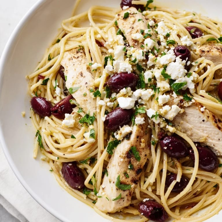 Vibrant Mediterranean pasta with cherry tomatoes, olives, and grilled chicken ready for a quick weeknight dinner.