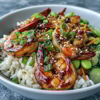 Sizzling grilled shrimp, crisp veggies, and fluffy jasmine rice topped with tangy ginger-sesame dressing.