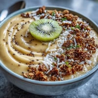 Vibrant Mango Chili Lime Smoothie Bowl with fresh fruit toppings.